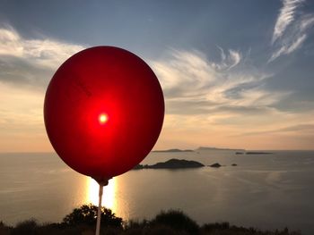 Red balloons at sunset