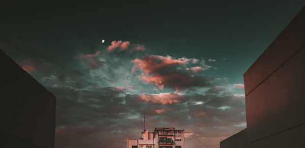 Low angle view of buildings against sky at sunset