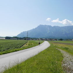 Country road passing through field