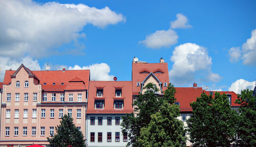 Low angle view of buildings against blue sky