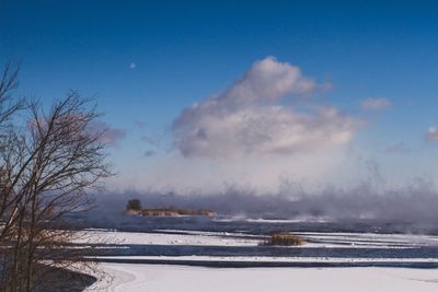 Scenic view of frozen lake against sky during winter