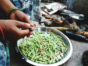 Cropped hands of woman preparing food at home