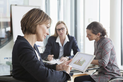 Businesswoman using digital tablet in a meeting