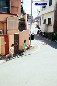 Vehicles on road along buildings