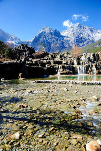 Scenic view of river and mountains on sunny day