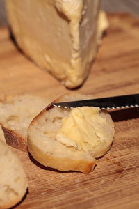 Close-up of bread with cheese on wooden table