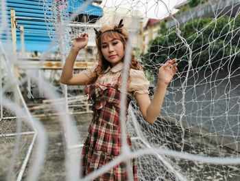 Portrait of young woman standing outdoors