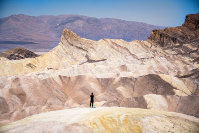 Rear view of man standing on mountain