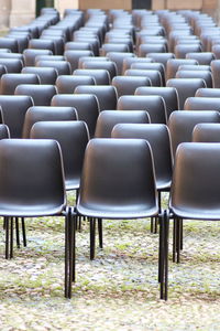 Empty chairs at arranged in a row