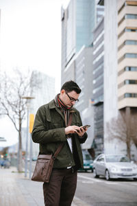 Man using mobile phone in city