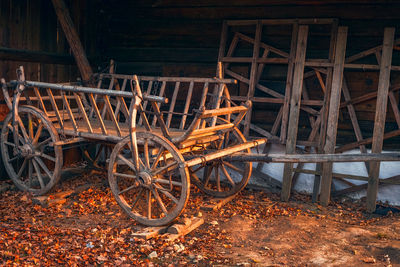 Old wooden empty cart at the farm in autumn