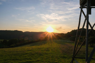 Scenic view of field against sky during sunset