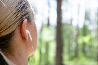 Close-up portrait of a teenage girl in forest