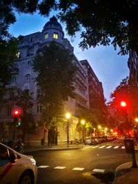 View of city street and buildings at night