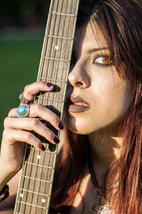 Portrait of woman holding guitar