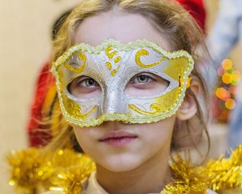 Close-up portrait of girl wearing mask