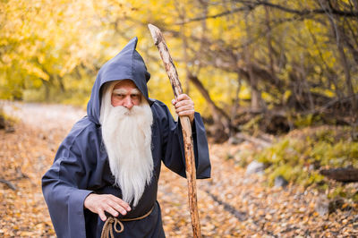 Mid adult man standing in forest