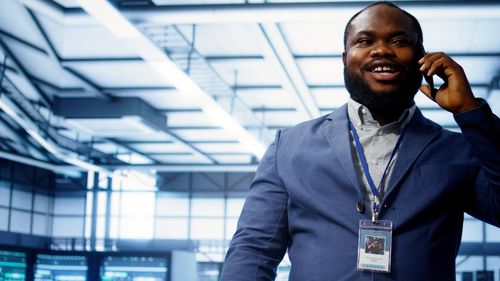 Portrait of young man standing in office