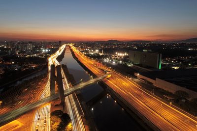 High angle view of light trails on road against sky at night