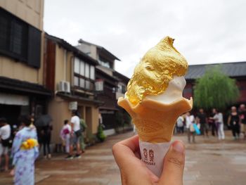 Close-up of hand holding ice cream cone