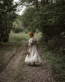 Rear view of woman standing on field