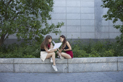 Two young women reading