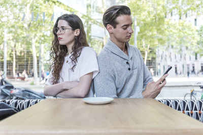Angry couple sitting at cafe