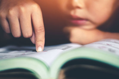 Close-up portrait of woman reading book