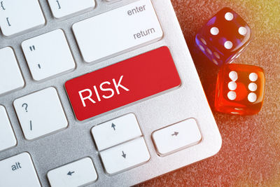 Close-up of dice by computer keyboard on table