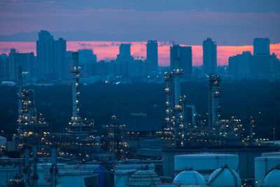 High angle view of illuminated buildings in city at sunset