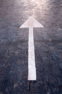 High angle view of arrow sign on road