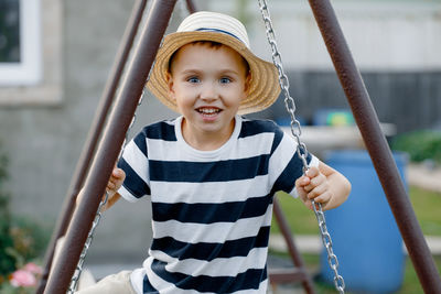 Portrait of cute boy on swing