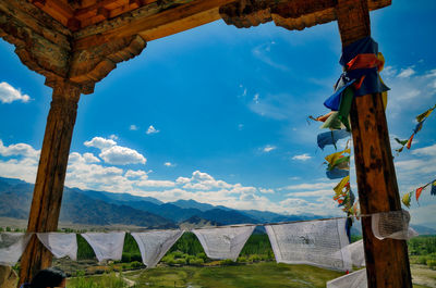 Built structure hanging on mountain against sky