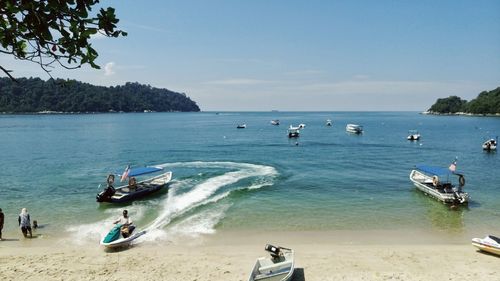 Boats in sea at beach