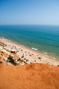 Scenic view of beach against clear blue sky