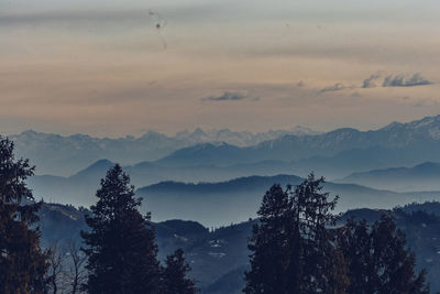 Scenic view of silhouette mountains against sky at sunset