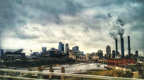 Cityscape against cloudy sky