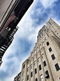 Low angle view of building against cloudy sky