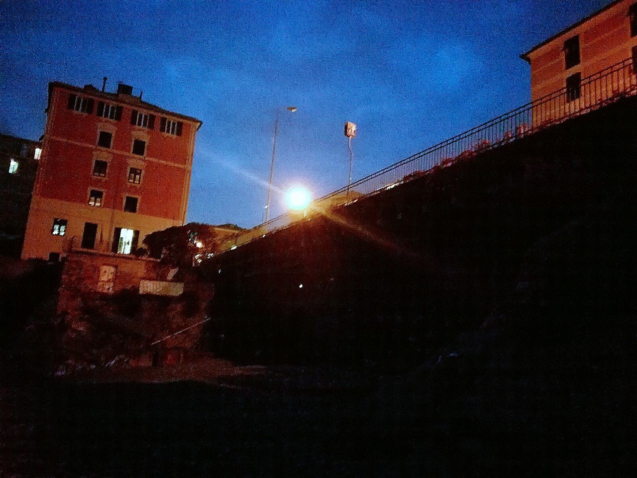 LOW ANGLE VIEW OF ILLUMINATED BUILDING AGAINST SKY