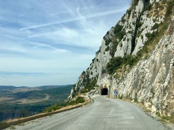 Road amidst mountains against sky