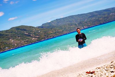 Man in sea against sky