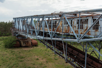 Train on bridge against sky