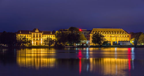 Reflection of illuminated buildings in river at night