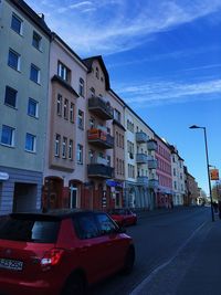 Cars on street by buildings in city