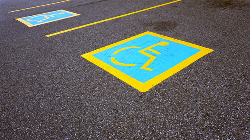 High angle view of wheelchair access signs on footpath
