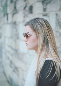 Side view of young woman in sunglasses