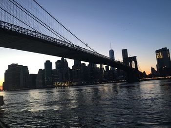 Low angle view of suspension bridge over river