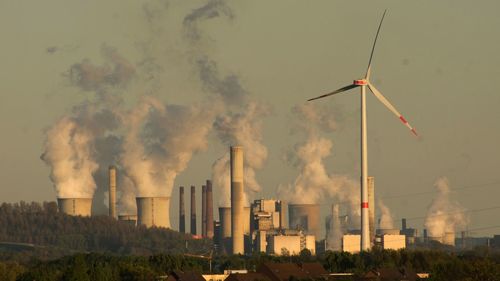 Smoke emerging from cooling towers at power plant