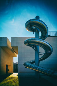 Low angle view of modern building against blue sky