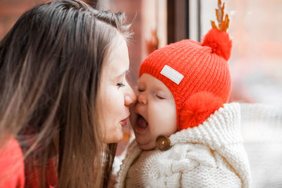 Close-up of mother and daughter at home